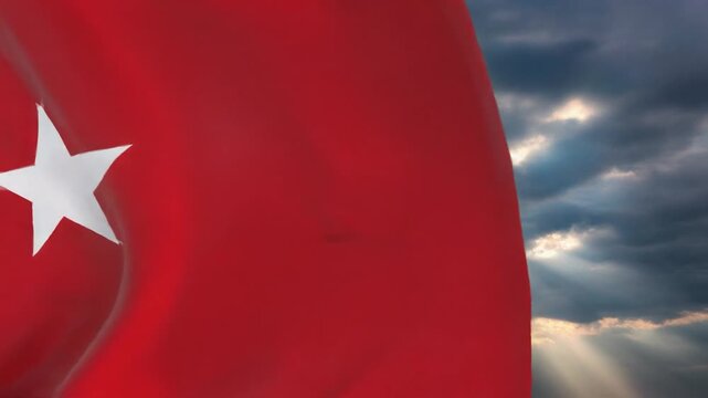 The Turkish flag waves majestically against a backdrop of dramatic clouds and sunbeams, symbolizing national pride and strength.