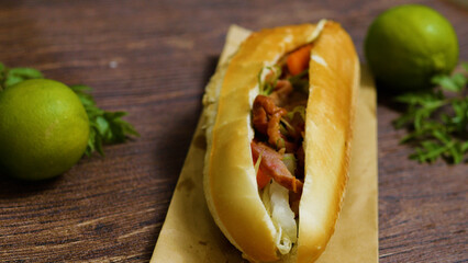 Freshly made vietnamese banh mi sandwich features grilled pork, pickled vegetables, cilantro, and a...