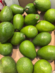 Fresh avocados piled together in a vibrant display at the market