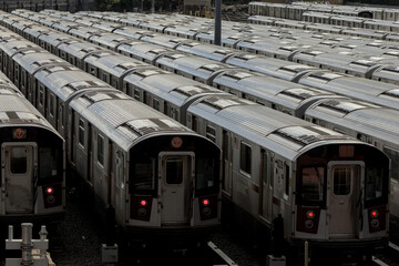 large group of 7 trains on tracks in train yard (corona flushing meadows queens new york city) transport commute transportation sunshine roofs cars car roof pattern lines abstract nyc commuter line