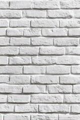 Obraz premium White Brick Wall Texture with Natural Lighting for Interior Design or Background Use