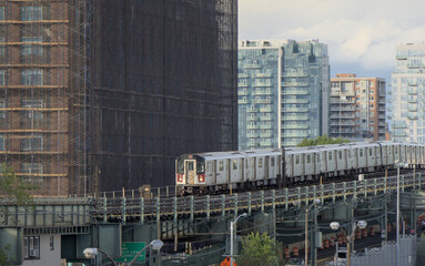 7 train running on above ground elevated tracks in flushing queens new york city (railroad commuter line)