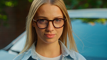 Confident Caucasian woman female businesswoman glasses looking at camera car dealer saleswoman...