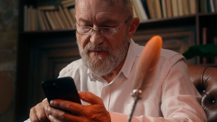 Confident successful old Caucasian man male mature takes off glasses looking at camera folded hands...