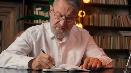 Confident successful old Caucasian man male mature takes off glasses looking at camera folded hands...