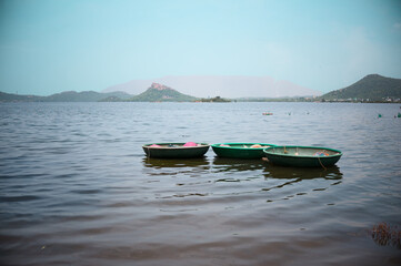 Boats floating peacefully on calm water at sunset
