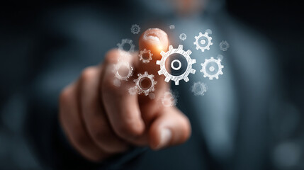 A finger pointing at digital gears floating in front of a dark background