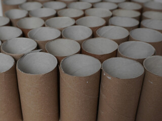 Cardboard toilet paper sleeves.
A close-up of a multitude of cardboard tubes, densely arranged in...