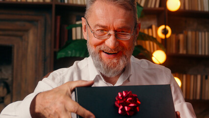Confident successful old Caucasian man male mature takes off glasses looking at camera folded hands...
