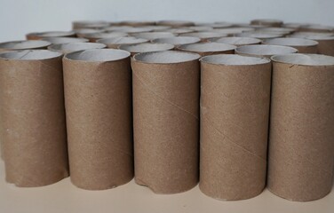 Cardboard packaging for toilet paper.Rows of empty cardboard cylinders arranged in a tight group....