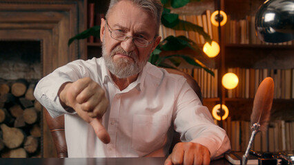 Confident successful old Caucasian man male mature takes off glasses looking at camera folded hands...
