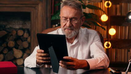 Confident successful old Caucasian man male mature takes off glasses looking at camera folded hands...