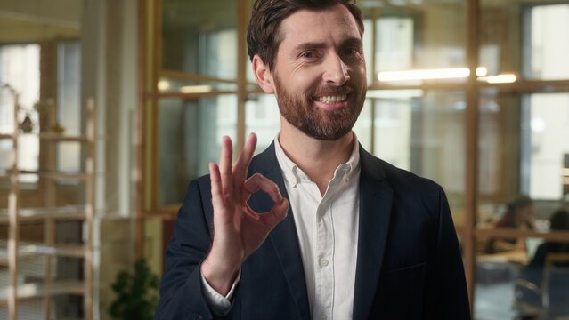 Caucasian businessman smiling in office showing ok sign business man portrait happy middle-aged male employer guy okay hand gesture satisfied entrepreneur at workplace success approve good recommend