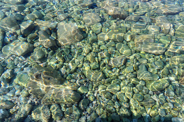 rocky bottom in clear blue sea water