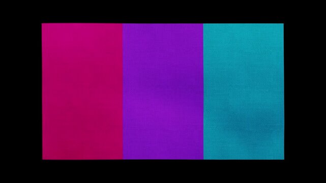 An LGBT Androgyne flag rolls and waves against a black background.
