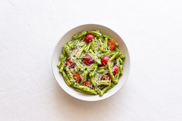 Pasta casarecce with pesto sauce, tomatoes and cheese. Italian cuisine. Vegetarian food.