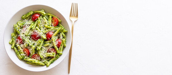 Pasta casarecce with pesto sauce, tomatoes and cheese. Italian cuisine. Vegetarian food.