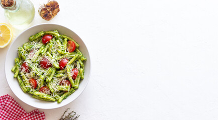 Pasta casarecce with pesto sauce, tomatoes and cheese. Italian cuisine. Vegetarian food.