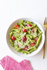 Pasta casarecce with pesto sauce, tomatoes and cheese. Italian cuisine. Vegetarian food.