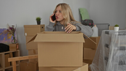 Woman unpacking boxes in new home while talking on phone in living room filled with moving supplies and cardboard packs suggesting a recent move.