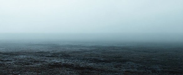 The serene landscape of fog enveloping a tranquil body of water.
