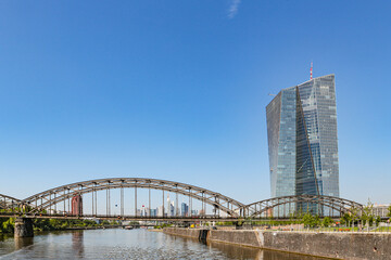 View of the Frankfurt skyline in Germany across the iron railway bridge from the Main River on the...