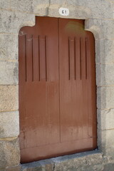 A brown door with the number 61 above it.