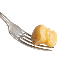 A cooked potato resting on a fork.
