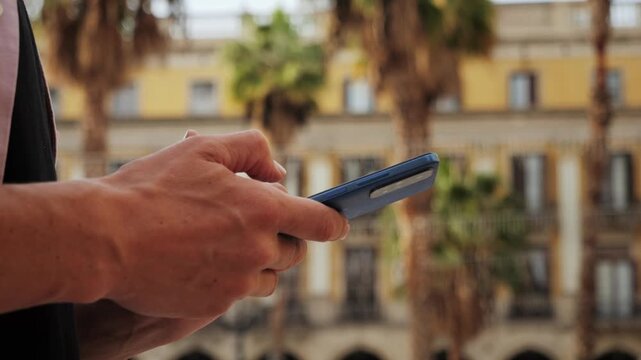 Man tourist using smart phone searching location in map application online close up macro. Backpacker using GPS to find destination on vacation. City or Forest hiking, walking in europe.