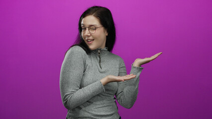 Woman with brown hair gestures confidently against a vibrant pink background wearing a gray sweater in various playful and expressive poses conveying emotion and curiosity.