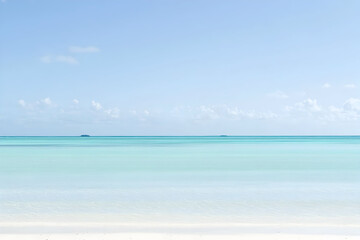 Naklejka premium Serene turquoise sea and blue sky with small islands on the horizon on a sunny day
