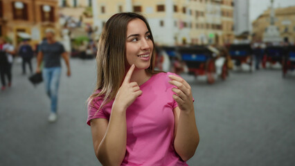 Blonde woman in pink shirt examines menstrual cup on a lively urban street, with people walking in...