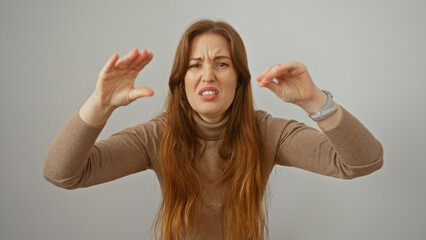 Woman expressing displeasure with arms raised isolated over white background in studio setting...