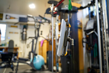 Close up of tablet showing online fitness class in gym.