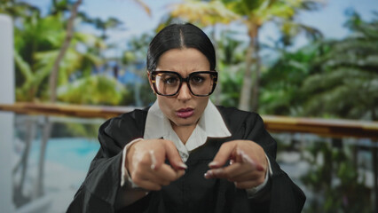 Woman in glasses wearing judge uniform appears surprised outdoors near pool at tropical resort...
