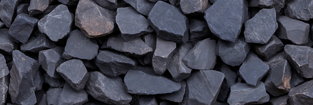 Poster pile of dark gray and black rocks in varying shapes and sizes, creating a textured surface with shar
