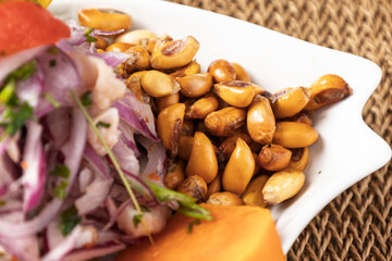 Ceviche with cancha, peruvian traditional food, close-up on a plate