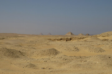 Landscape of the archaeological area of Saqqara. View of the Giza Pyramids at the rear. Egypt.