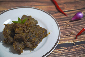 traditional Indonesian beef rendang on plate, authentic spicy meat dish