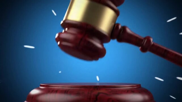wooden judge's gavel about to strike a sounding block against a blue background.