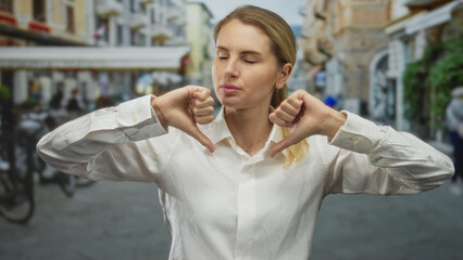 Woman expressing negative emotion on a bustling city street with a playful gesture, emphasizing...