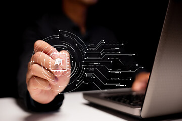 A person interacts with a digital AI chip icon hovering near a laptop, symbolizing artificial...