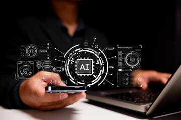 A person interacts with a smartphone and laptop, displaying AI and technology-themed digital...