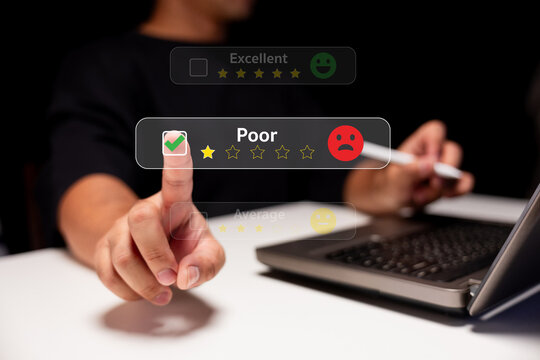 A person uses a laptop to give a poor rating with a sad face icon, highlighting negative feedback on a digital review interface.