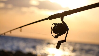 Fishing rod at sunset over water
