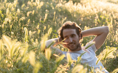 Young and fit man is relaxing outdoors with idyllic sunlight