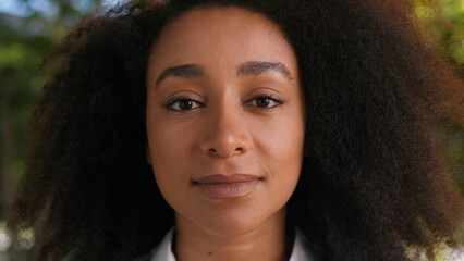 Close up young African American face woman businesswoman female looking at camera entrepreneur boss...