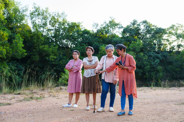 Obraz premium Senior Asian women discussing direction map outdoor nature casual clothing cheerful planning vacation travel adventure freedom leisure lifestyle journey friendship happiness environment sightseeing