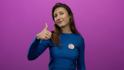Woman smiling with thumbs up and a vote badge on a pink background, expressing support and civic...