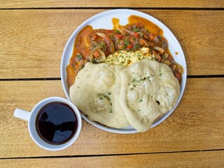 A typical Panamanian breakfast with eggs in creole sause and hojaldres with black, high-altitude coffee (overhead)